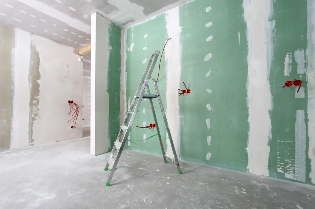 Green drywall panels installed in a room during construction