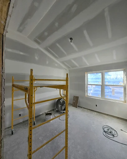 Unfinished drywall walls and ceiling inside a residential room